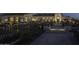Inviting clubhouse patio with stone accents, lush landscaping, and ambient lighting for evening enjoyment at 18322 W Thistle Landing Dr, Goodyear, AZ 85338