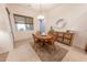 Cozy dining area featuring tile flooring, custom cabinetry, and a decorative buffet at 18322 W Thistle Landing Dr, Goodyear, AZ 85338