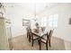 Well-lit dining room with a wood table, comfortable seating, and plantation shutters at 18322 W Thistle Landing Dr, Goodyear, AZ 85338