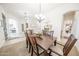 Dining room featuring a wood table with seating for six, a chandelier, and an open layout at 18322 W Thistle Landing Dr, Goodyear, AZ 85338