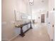 Elegant entryway featuring a decorative mirror and a view into the dining area at 18322 W Thistle Landing Dr, Goodyear, AZ 85338
