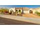 Charming home featuring desert landscaping, tile roof, and a brick paver driveway at 18322 W Thistle Landing Dr, Goodyear, AZ 85338