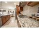 Modern kitchen features granite countertops, stainless steel appliances, and a gas cooktop at 18322 W Thistle Landing Dr, Goodyear, AZ 85338