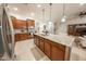 Stylish kitchen includes stainless appliances, a large island, and opens to the living area at 18322 W Thistle Landing Dr, Goodyear, AZ 85338