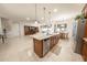 Spacious kitchen with a central island, stainless steel appliances, and open layout to living spaces at 18322 W Thistle Landing Dr, Goodyear, AZ 85338