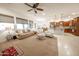 Bright living room with an open floor plan, seamlessly connecting to the kitchen at 18322 W Thistle Landing Dr, Goodyear, AZ 85338