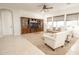 Open-concept living room with a large entertainment center and comfortable seating at 18322 W Thistle Landing Dr, Goodyear, AZ 85338