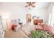 Inviting living room with a ceiling fan, comfortable seating, and arched doorway at 18322 W Thistle Landing Dr, Goodyear, AZ 85338