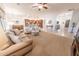 Open layout living room flows into the dining area and features large windows and natural light at 18322 W Thistle Landing Dr, Goodyear, AZ 85338