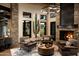 Inviting lobby featuring a stacked stone fireplace, comfortable seating, and natural light at 18322 W Thistle Landing Dr, Goodyear, AZ 85338