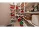Large walk-in pantry maximizes storage with numerous shelves for organized convenience at 18322 W Thistle Landing Dr, Goodyear, AZ 85338