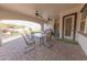 Covered patio has brick flooring and view of the well maintained outdoor space at 18322 W Thistle Landing Dr, Goodyear, AZ 85338