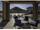 Stunning pool area with comfortable lounge seating, umbrellas, and scenic mountain views, perfect for relaxation at 18322 W Thistle Landing Dr, Goodyear, AZ 85338