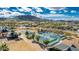 Aerial view of well-maintained tennis courts surrounded by lush landscaping in a vibrant community setting at 18322 W Thistle Landing Dr, Goodyear, AZ 85338