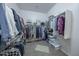 Organized walk-in closet featuring ample shelving, hanging space, and a neutral color palette at 18322 W Thistle Landing Dr, Goodyear, AZ 85338
