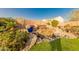 Beautiful backyard water feature with decorative planters enhances the outdoor living space at 18322 W Thistle Landing Dr, Goodyear, AZ 85338