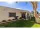 Backyard view of the house, patio, and well-maintained lawn area at 18745 N 92Nd Dr, Peoria, AZ 85382