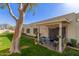 Private patio with seating and views of the well-maintained backyard and lawn at 18745 N 92Nd Dr, Peoria, AZ 85382