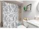 Cozy bathroom features patterned shower curtain, granite sink top, and decorative accents at 18745 N 92Nd Dr, Peoria, AZ 85382