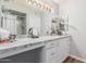 Well-lit bathroom vanity with granite countertops, decorative lighting, and updated fixtures at 18745 N 92Nd Dr, Peoria, AZ 85382