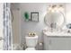 Bathroom featuring a toilet, shower with blue and white curtain and granite sink top at 18745 N 92Nd Dr, Peoria, AZ 85382