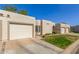 Beautiful home with a two-car garage, desert landscaping, and a well manicured lawn at 18745 N 92Nd Dr, Peoria, AZ 85382