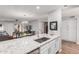 Spacious kitchen island featuring stainless steel sink and granite countertops at 18745 N 92Nd Dr, Peoria, AZ 85382