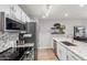 Bright kitchen features stainless steel appliances, granite countertops, and modern backsplash at 18745 N 92Nd Dr, Peoria, AZ 85382