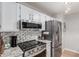Updated kitchen features modern stainless steel appliances, white cabinets, and granite countertops at 18745 N 92Nd Dr, Peoria, AZ 85382