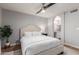 Bright main bedroom with ensuite bathroom access featuring neutral walls and a ceiling fan at 18745 N 92Nd Dr, Peoria, AZ 85382