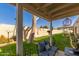 Comfortable covered patio with seating and view of the lush green lawn at 18745 N 92Nd Dr, Peoria, AZ 85382