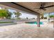 Backyard patio area with steps leading to a pool, offering a serene outdoor living space at 18860 N 73Rd Dr, Glendale, AZ 85308