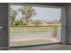 Backyard view showing the fenced yard, lawn, pool and neighborhood through a covered porch at 18860 N 73Rd Dr, Glendale, AZ 85308