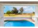 Balcony view overlooking the golf course and sparkling pool offering serene outdoor relaxation at 18860 N 73Rd Dr, Glendale, AZ 85308