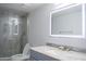 Bright bathroom featuring a glass shower, modern vanity, a vessel sink and an LED mirror at 18860 N 73Rd Dr, Glendale, AZ 85308