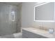 Beautiful bathroom featuring an elegant lighted mirror, marble countertop, and walk-in glass shower at 18860 N 73Rd Dr, Glendale, AZ 85308