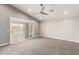 Bedroom with plush carpeting, ceiling fan, and sliding glass door at 18860 N 73Rd Dr, Glendale, AZ 85308