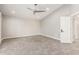 Spacious bedroom with plush carpeting, ceiling fan, and walk-in closet at 18860 N 73Rd Dr, Glendale, AZ 85308