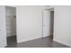 Bright, vinyl-floored bedroom featuring a large closet, white trim, and an open doorway at 18860 N 73Rd Dr, Glendale, AZ 85308