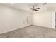 A bright bedroom features neutral walls, carpet flooring, and a window with an arched top and shutters at 18860 N 73Rd Dr, Glendale, AZ 85308