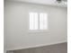 Minimal bedroom showcasing wood-look flooring, a shuttered window, and light, neutral walls at 18860 N 73Rd Dr, Glendale, AZ 85308