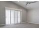 Spacious bedroom featuring vaulted ceiling, decorative wall, sliding doors, and a ceiling fan at 18860 N 73Rd Dr, Glendale, AZ 85308