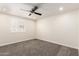 Bedroom with neutral walls, carpet flooring, ceiling fan, and window with plantation shutters at 18860 N 73Rd Dr, Glendale, AZ 85308