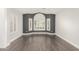 Bright bedroom with a large arched window, light gray walls, and wood-look flooring at 18860 N 73Rd Dr, Glendale, AZ 85308