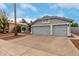 Gray two-story home featuring a three-car garage and desert landscaping at 18860 N 73Rd Dr, Glendale, AZ 85308