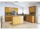 Spacious kitchen with natural wood cabinets, stainless steel appliances, and tile flooring at 18860 N 73Rd Dr, Glendale, AZ 85308