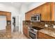 Kitchen with stainless steel appliances, granite countertops, and a view to another room at 18860 N 73Rd Dr, Glendale, AZ 85308