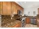 Well-lit kitchen features stainless steel appliances and granite countertops at 18860 N 73Rd Dr, Glendale, AZ 85308
