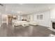 Spacious living room with modern white furniture, fireplace, and wood-look flooring at 18860 N 73Rd Dr, Glendale, AZ 85308