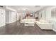 Spacious living room featuring a wet bar, white sofas, wood floors, and a fireplace at 18860 N 73Rd Dr, Glendale, AZ 85308